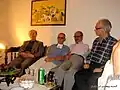 از راست؛ جلال خالقی مطلق، محمدرضا شفیعی کدکنی، ایرج افشار و دکتر حسین میرمجلسی، نقاشی روی دیوار اثر استاد پرویز کلانتری.