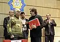 دکتر جلال خالقی مطلق، یک دوره دو جلدی با قاب از دومین ویرایش شاهنامه را به استاد شهرام ناظری اهدا می‌کند. دیگر نفرات حاضر در عکس، به ترتیب از راست؛ سجاد آیدنلو، محمد افشین وفایی و علی‌اشرف صادقی، شبِ شاهنامه (یک صد و نود و چهارمین شبِ بخارا)، پنج شنبه ۲۱ اسفند ۱۳۹۳.