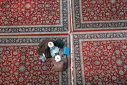 دو روحانی در مدرسه خان قم در حال «مباحثه» درس‌های خارج