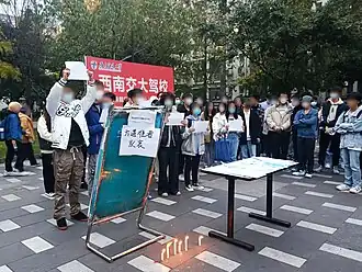 Protesters march towards a local government building