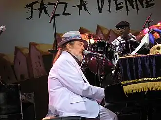 Dr. John in a wide-brimmed hat and sunglasses