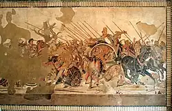 A large mosaic depicting an array of soldiers on horseback doing battle. Parts of it have been damaged or lost to time.