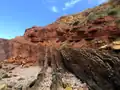 دگرشیبی زاویه‌ای در سنگ‌های دوره تریاس، رسوبات به‌شدت کج‌شده کربنیفر در Praia do Telheiro, پرتغال را پوشانده‌اند.