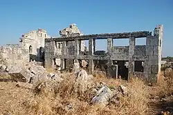 Villa in Barisha with porch pillars, to the left is the east gable of the Basilica
