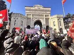 Protests by university students in front of Beyazıt Square in Istanbul, in front of a Istanbul University Gate with protesters waving several banners with Turkish flags and protest statements