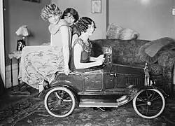 The Brox Sisters, posed with toy car. Left to right: Loryane, Bobbe, Patricia.