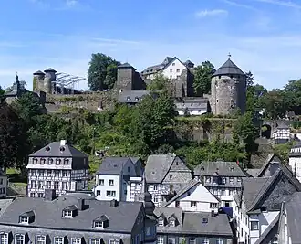 Slate-roofs of Monschau town centre and castle.The castle's courtyard in preperation for Monschau Open Air Klassik music festival