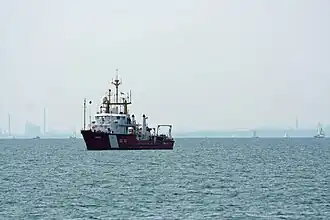 three-quarters front view of ship at anchor in Lake Ontario