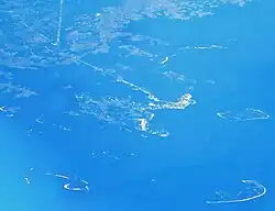 Aerial view of Cedar Key and its outlying islands, illustrating the extremely small size of the city.  The fork at State Roads 24 and 347 (the only two access roads) can be seen in the upper left.