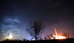 Moon rising near power station in Newark