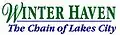 Winter Haven in a green serif font on top except for a cursive W, "The Chain of Lakes City" on bottom in an italicized sans serif font