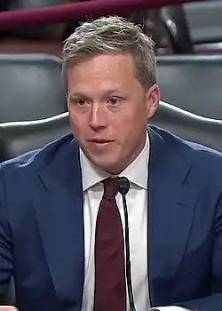 Headshot of Driscoll in a suit