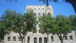 Trees block the view of the Eastland County Courthouse in Eastland