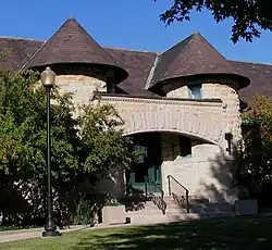 Entrance to the George C. Walker Library. The building and many of the books the library contained when it opened were a gift of George C. Walker, then president of the Blue Island Land and Building Company (his predecessor being F.H. Winston, a prominent Chicago attorney). The original portion of the building was designed by Charles Sumner Frost and cost $12,000. It opened on April 22nd, 1890, was expanded by an addition that quadrupled its space in 1929, and received a major renovation in ۱۹۹۵.