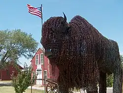 Barbed-wire buffalo sculpture stands in front of the Fort Wallace Museum, in 2006
