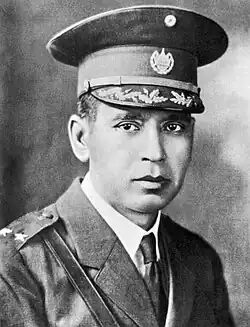 A black-and-white upper-body photograph of Maximiliano Hernández Martínez in early- to mid-20th century military dress uniform facing the viewer