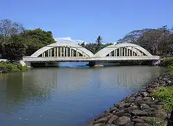 Historic twin-span "Rainbow Bridge" over the Anahulu River marks the north end entrance to old Haleʻiwa Town