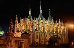 Church of St Barbara, a large Gothic building, at night