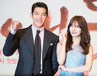 A photograph of My Love from the Star lead actors, smiling and posing for the camera on the stage of the 50th Baeksang Arts Awards