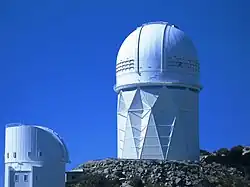 <!Two of Kitt Peak's telescopes (right: Mayall 4-m telescope; left: Bok 2.3-m telescope)>