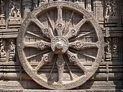 Decorated wheel in stone relief.