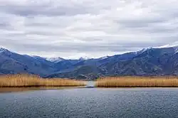 Lake with surrounding tree-covered hills