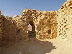 Ruins of a buiding made of unhewn stones.