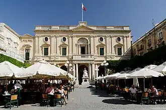 a white stone eighteenth-century building with a pillared portico