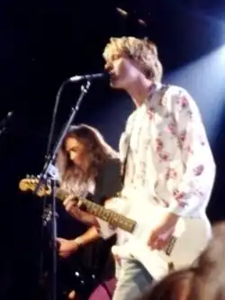 Cobain wearing headphones at a microphone