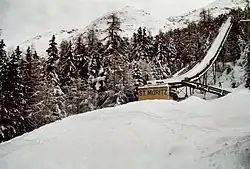 A view of a ski jump hill with crowds