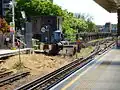 Southern end of the platforms at Putney Bridge station, showing the reversing siding, the World War 2 pillbox defending the bridge, and the northern tip of the bridge