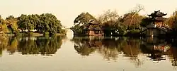 A lake with a bridge and a pagoda on the lakeside.
