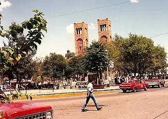 The Plaza Guillermo Baca in downtown Parral, showing the Searcher of Dreams Fountain and the Cathedral Shrine of Our Lady of Guadalupe, seat of the Diocese of Parral