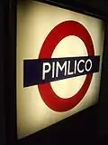 Platform roundel, back-lit, producing contrast in this photo