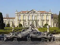 The front facade of the Queluz National Palace, with one of the ornate fountains