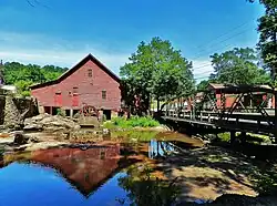 The ثبت ملی اماکن تاریخی listed Rex Mill, as seen from the side of Mill Walk west of the one-lane bridge.