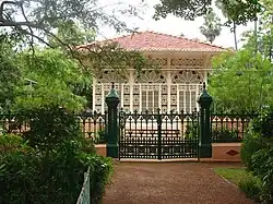 A building with elaborate facade behind a metal fence