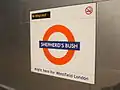 Platform roundel, based on the famous symbol of London Transport, but with Overground orange circle