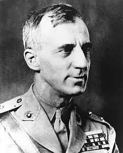 An adult male looking to the right in a military uniform; military ribbons are visible.