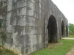 A gate built of massive grey stones.