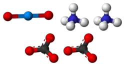 Ball-and-stick model of the component ions of ammonium uranyl carbonate, showing one uranyl cation (top-left), two ammonium cations (top-right) and two carbonate anions (bottom).