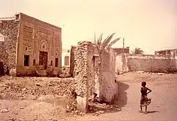 Partially ruined stone building with a decorated facade.