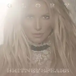 The album's deluxe cover features a close-up image of Spears with a bright light in the background. The album title is written on top of the image, while Britney Spears' name is written below her image.