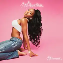 A young black woman looks at the camera while sitting on a floor against a pink background.
