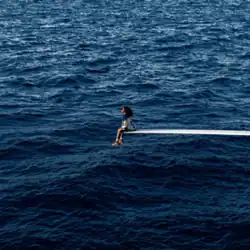 Cover art for "SOS": SZA sitting at the edge of a diving board in the middle of the sea