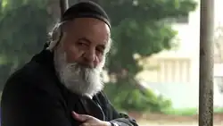 Shalom Nagar in his seventies with a grey beard and wearing a dark kippah