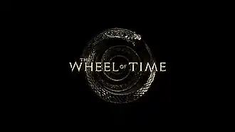 The logo shows the words "The Wheel of Time" on top of a coiled silver snake