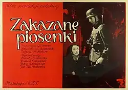 The film still shows two young boys dressed in captured German military uniforms, with Polish national colours marked on the helmet of one of them, armed with bolt action rifles, passing a street under enemy fire during the Warsaw Uprising.