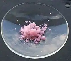 Erbium(III) chloride hydrate photographed in sunlight