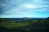 Picture of the black sand mountain Hjörleifshöfði in the distance, viewed from the foothills of the Katla volcano to the northwest